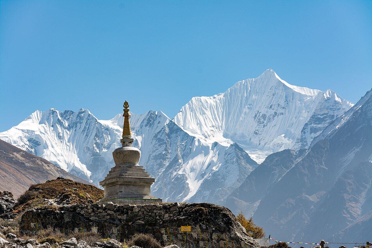A stupa in Langtang valley with snow peaks behind