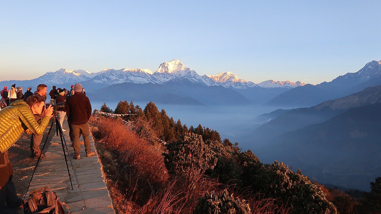 Trekkers watching sunrise over Dhaulagiri from Poon Hill